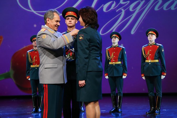 Russian Minister of Defense Sergey Shoigu is awarding his deputy, General of the Army Tatiana Shevtsova