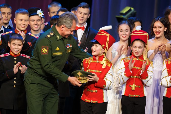 Russian Minister of Defense Sergey Shoigu meets young cadets after performance