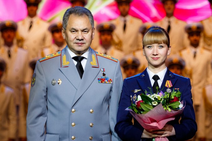 Russian defense minister, General of the Army Sergey Shoigu and a female warrant officer